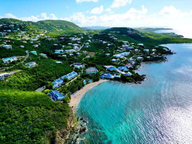 Aerial view of a coastal area with houses and a beach.