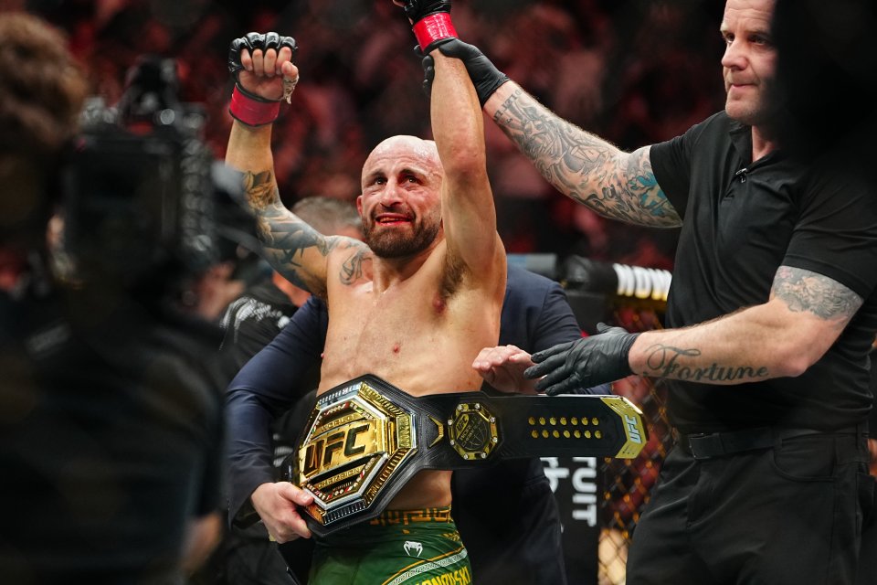 Alexander Volkanovski holding the UFC championship belt after a fight.