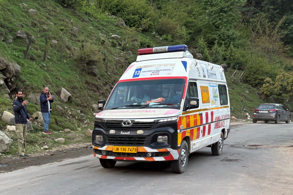 Ambulance driving on a road after a suspected militant attack.
