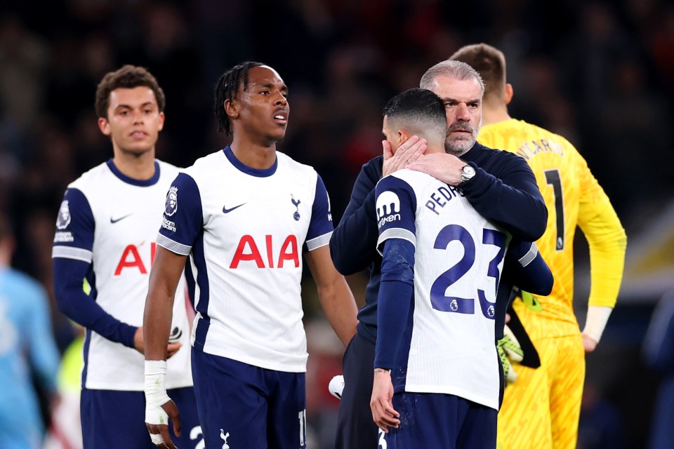 Ange Postecoglou, Tottenham Hotspur manager, consoles a player after a match.