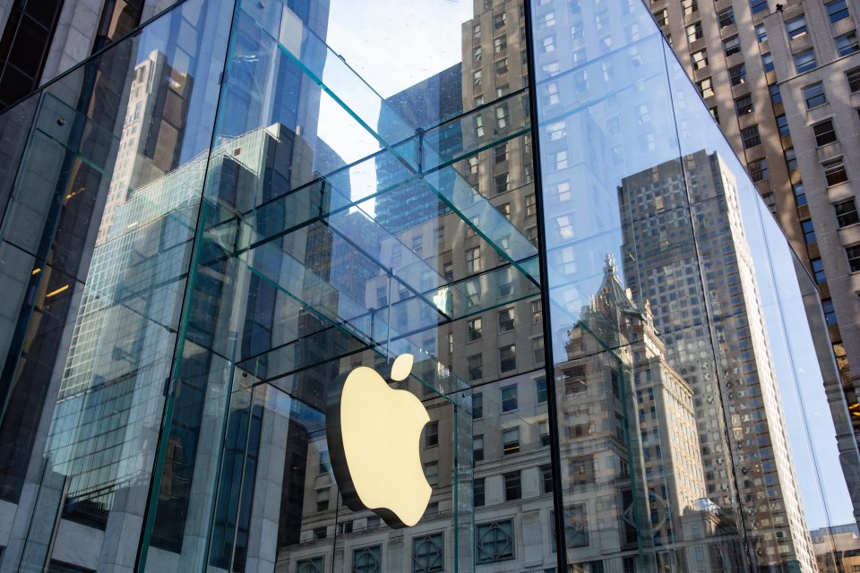 Apple logo reflected in the glass facade of its Fifth Avenue store in New York City.