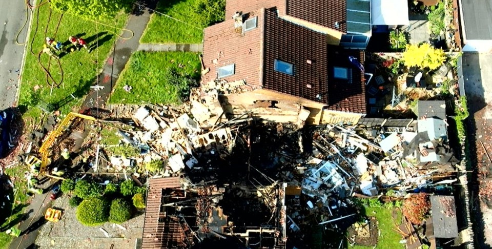 Aerial view of a house destroyed by an explosion.