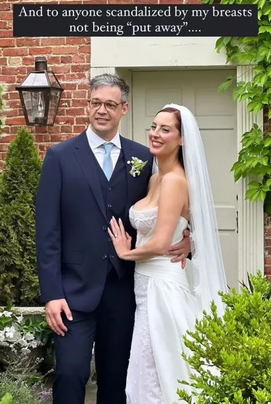 A bride and groom pose for a wedding photo.