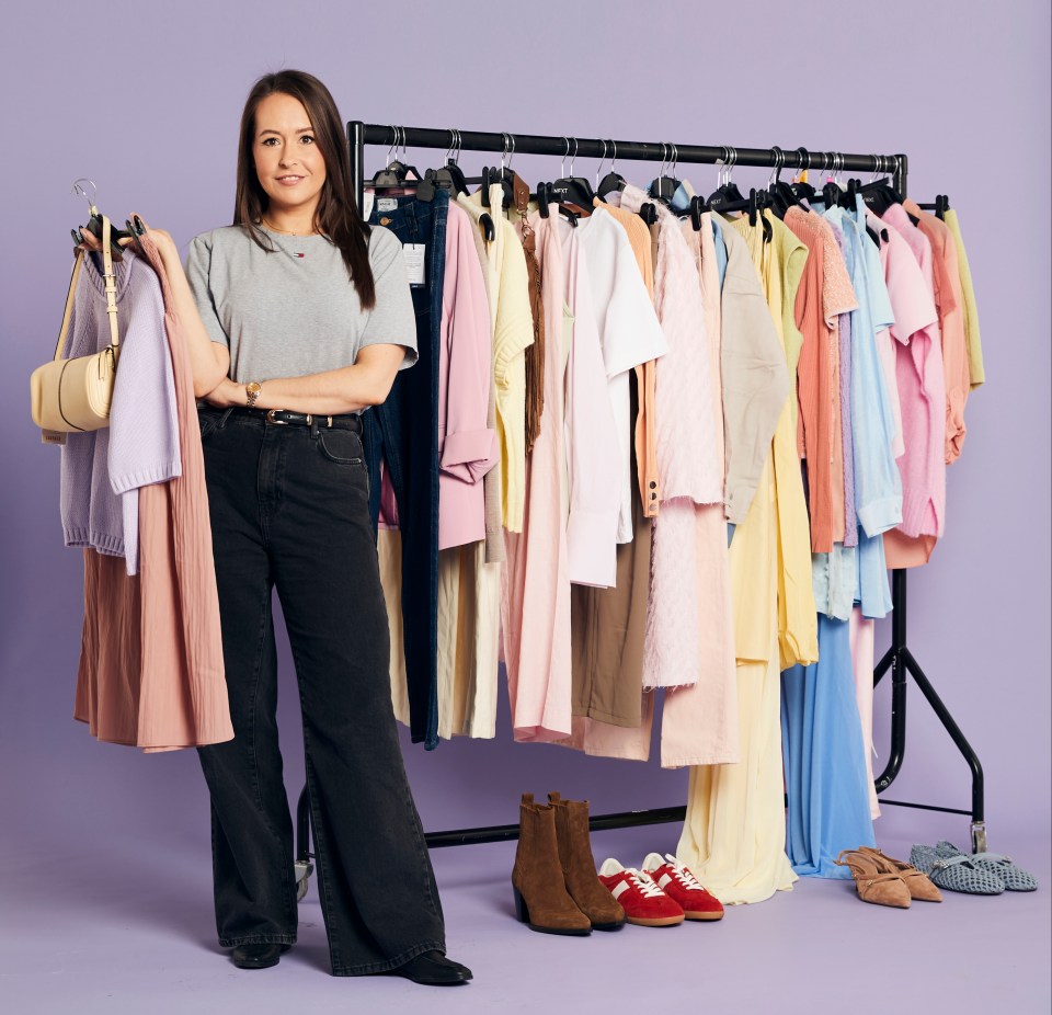 Woman standing in front of clothing rack with various pastel-colored clothing items.