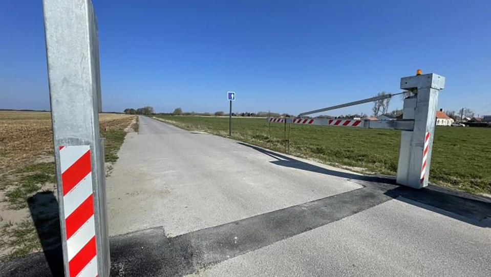 Barrier blocking a road near Calais to prevent migrant crossings.
