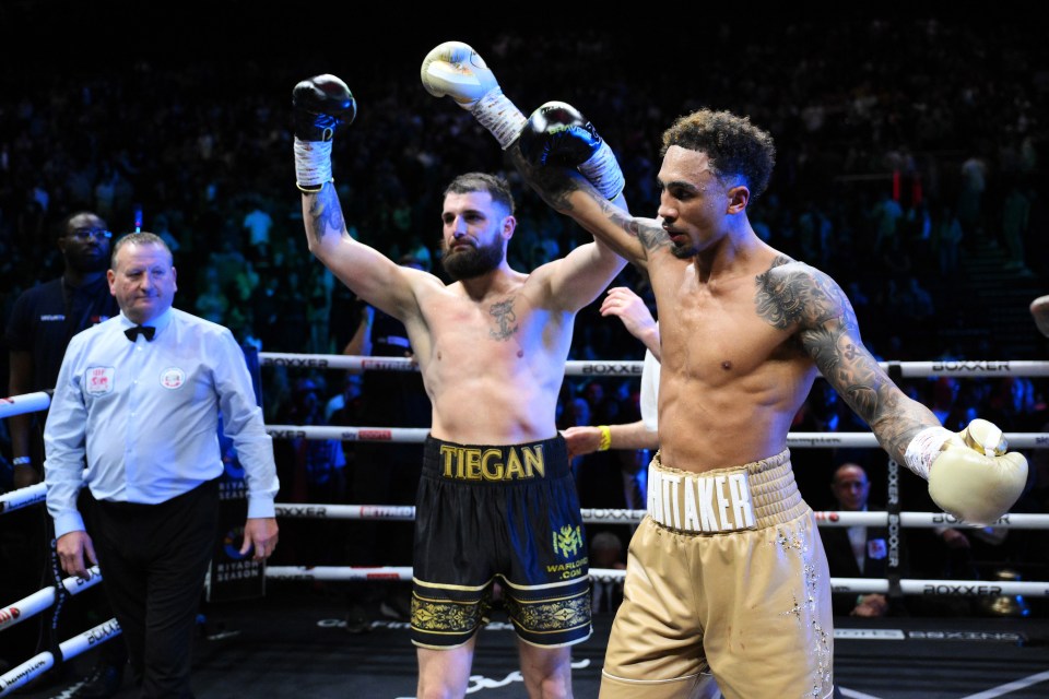 Ben Whittaker raises Liam Cameron's hand after a boxing match.