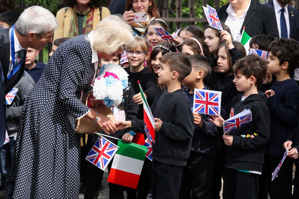 Queen Camilla speaking at a school during a state visit.