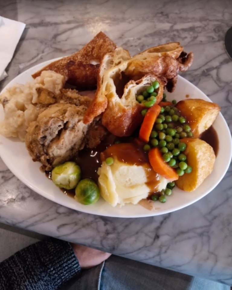 Roast dinner with meat, potatoes, vegetables, and Yorkshire pudding.