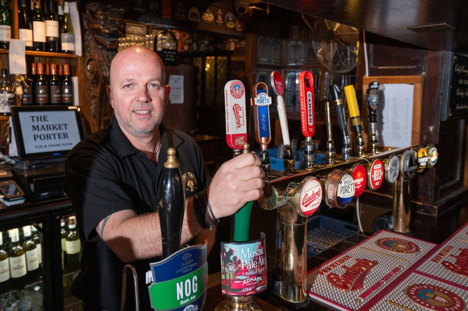 Bartender at The Market Porter pub pulling a pint.