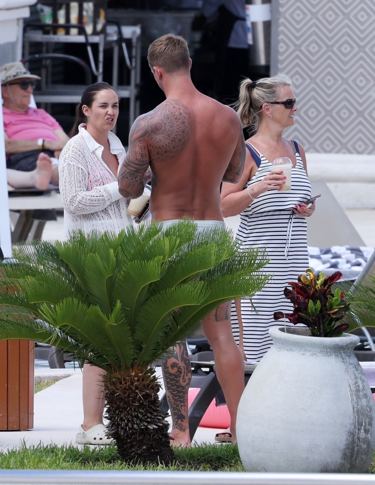 Jacqueline Jossa and Dan Osborne relaxing by a pool in Cancun.