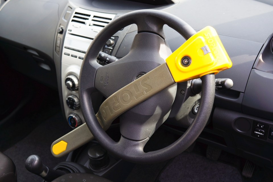 Person unlocking a car with a key fob.