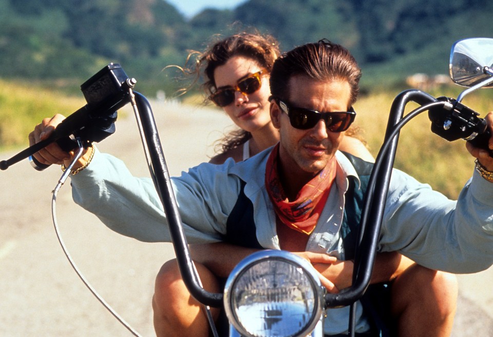 Mickey Rourke and Carré Otis riding a motorcycle in a scene from *Wild Orchid*.
