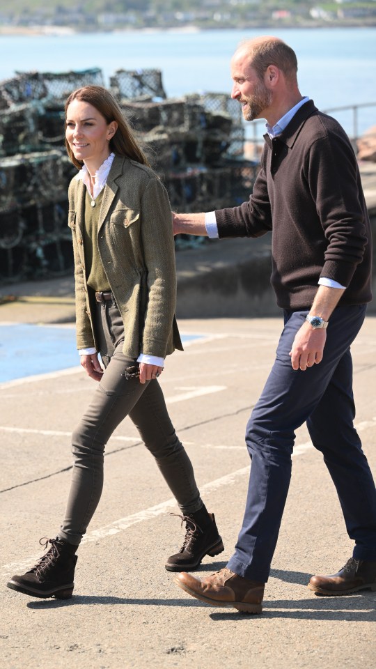 Catherine, Princess of Wales and Prince William walking on a dock.