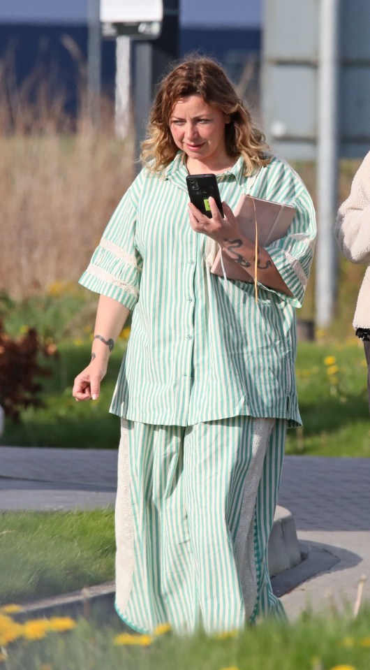 Charlotte Church using a phone outside a hotel.