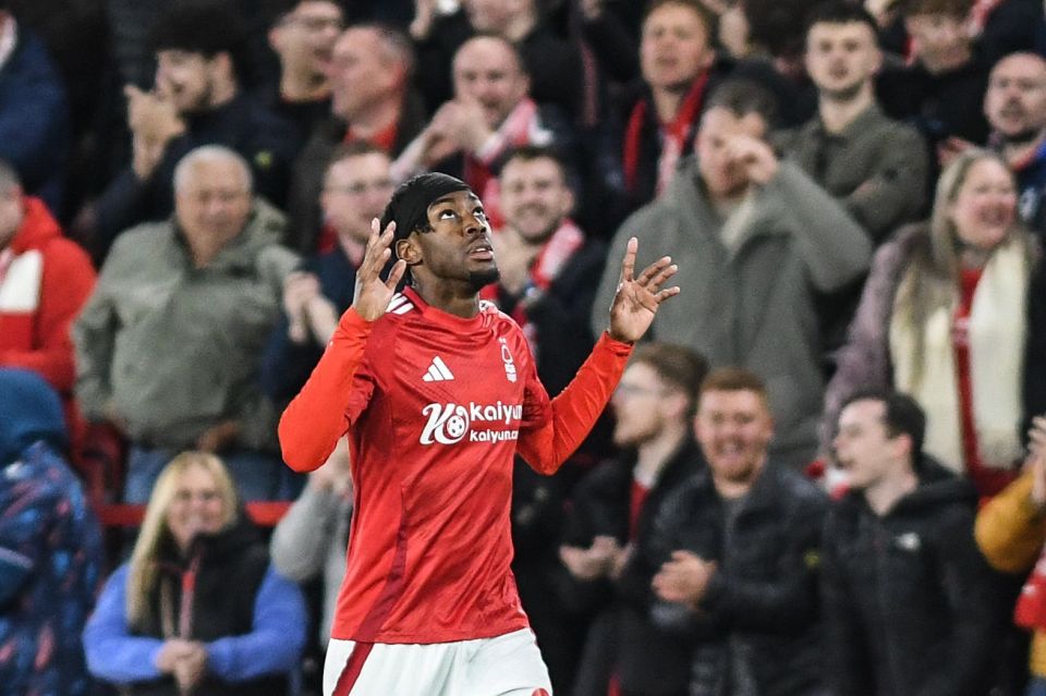 Soccer player celebrating a goal in front of cheering fans.