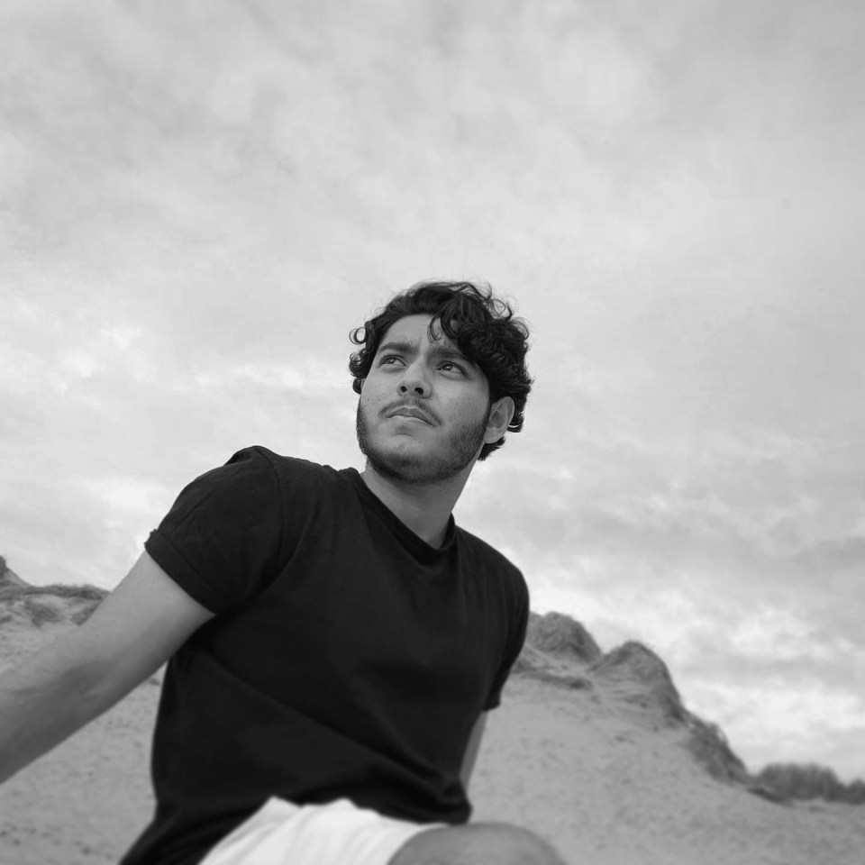 Black and white photo of a man looking up.