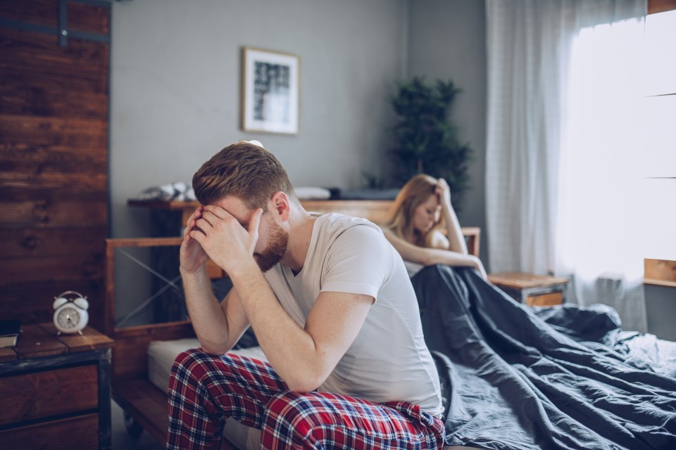 Couple arguing in bed.