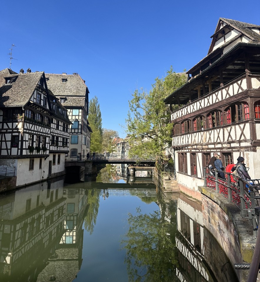 Canal in Colmar, France, with half-timbered houses.