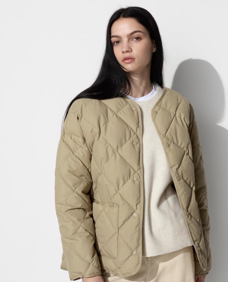 Woman wearing a beige quilted jacket.