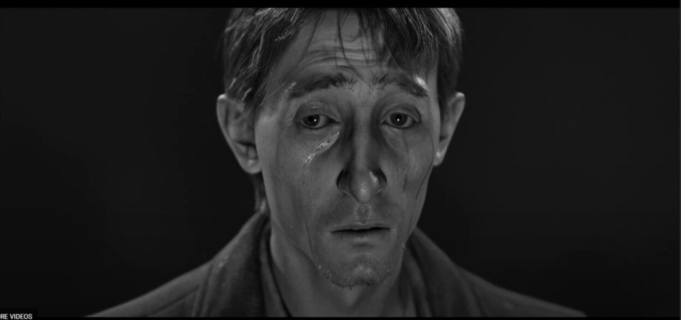 Black and white image of a man from the game KARMA: THE DARK WORLD.