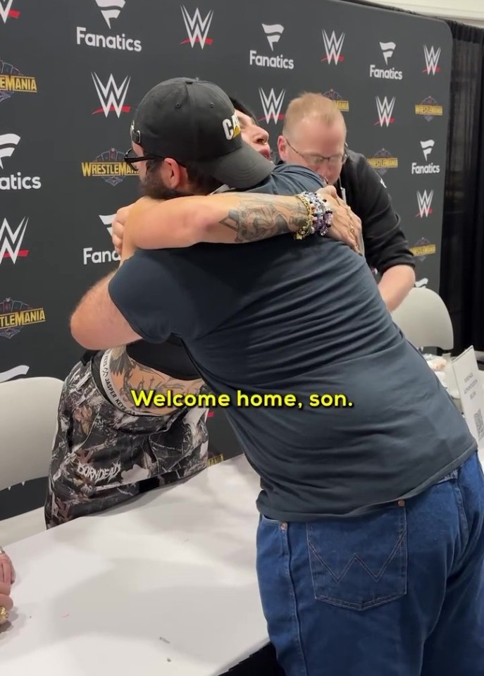 A WWE wrestler embracing a fan.
