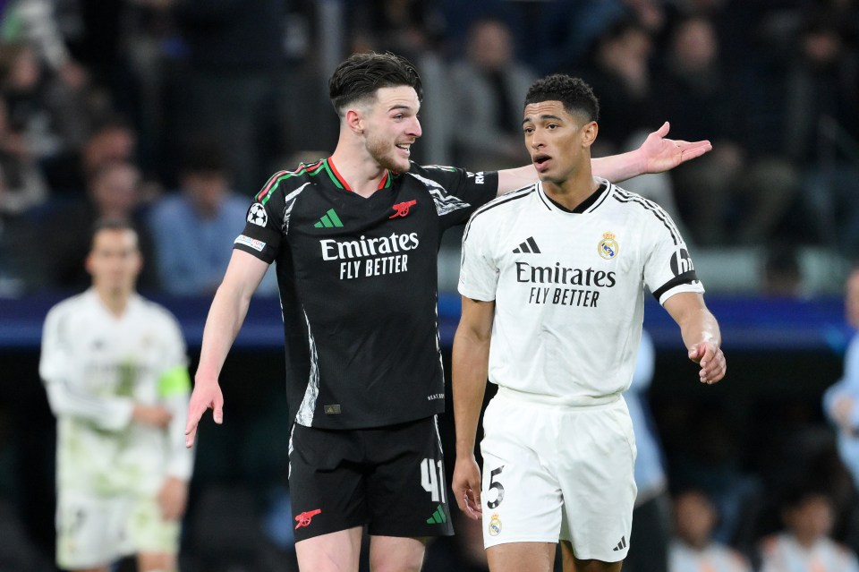 Declan Rice of Arsenal and Jude Bellingham of Real Madrid talking on the field.