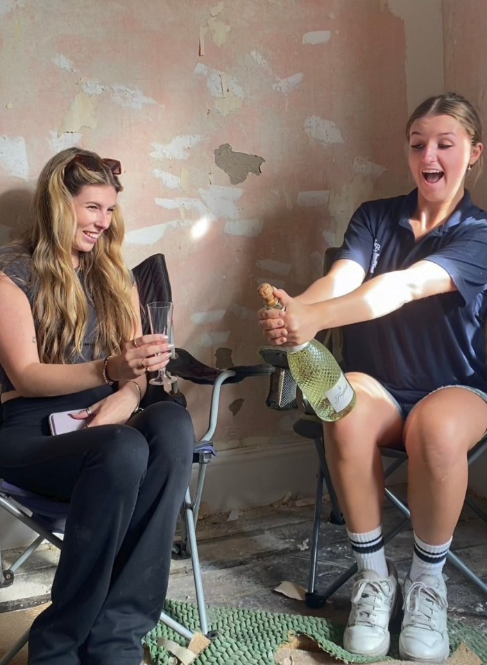 Two sisters celebrating in their renovated flat.
