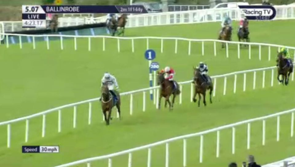 Horses racing on a track.