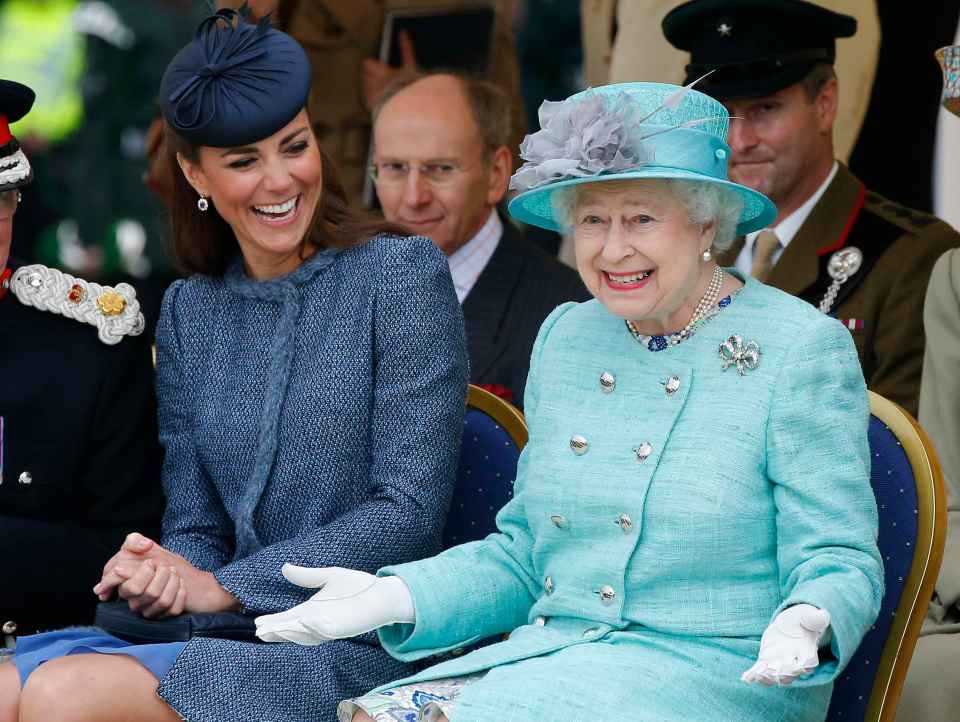 The Duchess of Cambridge and Queen Elizabeth II laughing together at a children's sports event.