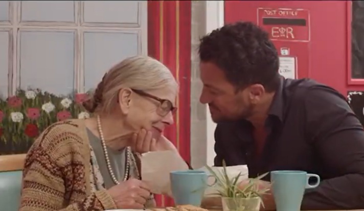 Peter Andre with an elderly woman in a movie scene.