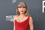 Taylor Swift at the Grammy Awards in a red dress.