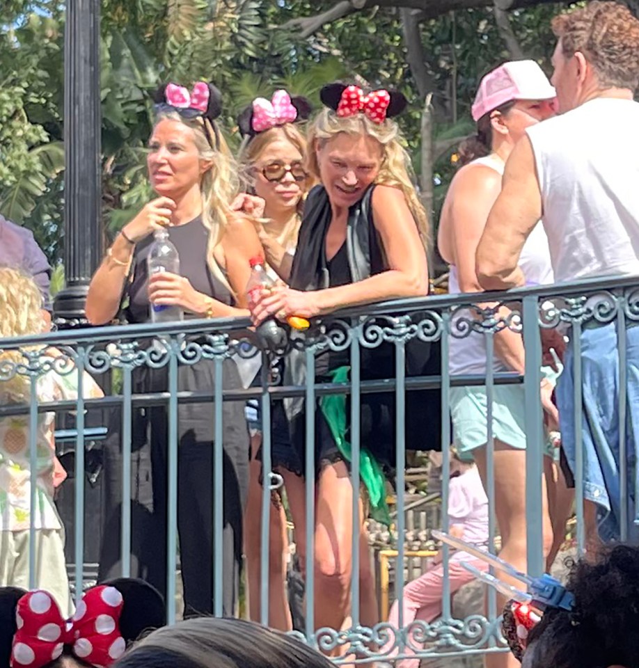 Kate Moss and friends at Disney World wearing Minnie Mouse ears.
