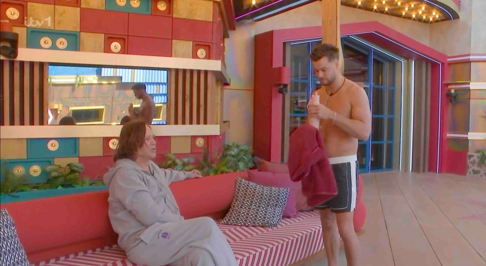 Screenshot from Celebrity Big Brother showing Chris Hughes comforting JoJo Siwa.
