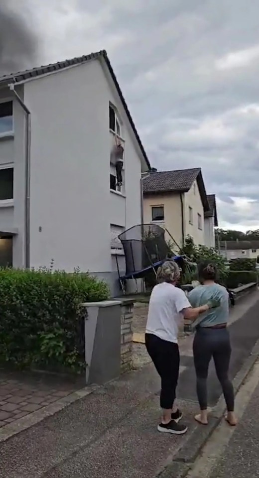 Man escaping burning building by jumping onto a trampoline.