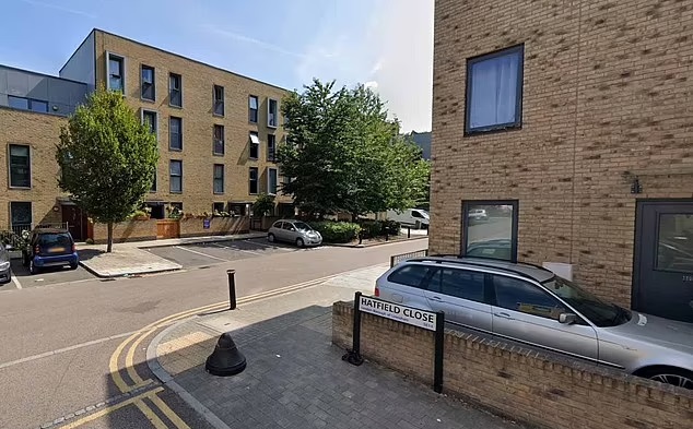 Street view of Hatfield Close in London, showing residential buildings and parked cars.