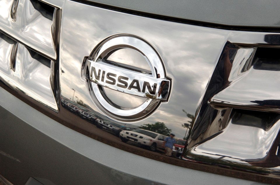 Close-up of a Nissan Murano emblem on a vehicle's grill.