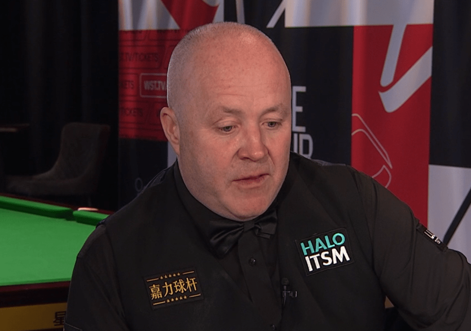 Close-up of a man in a snooker waistcoat.
