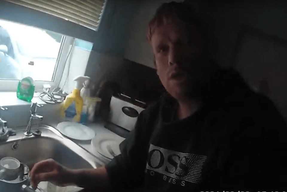 Man washing dishes in a kitchen.