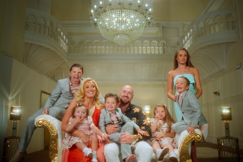 The Fury family posing for a photo on a gold chaise lounge.
