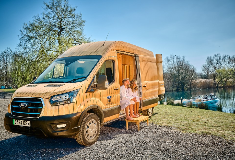Ford Transit van converted into a mobile sauna, with a couple relaxing inside.
