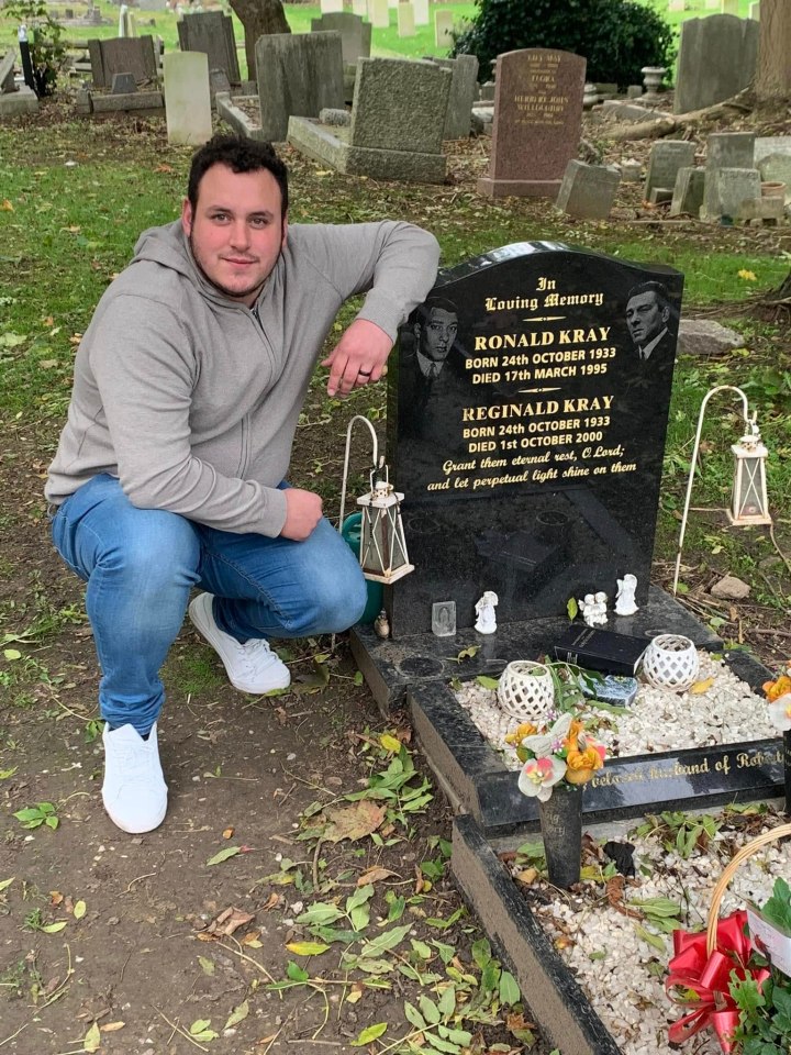 Man kneeling at the Kray twins' grave.