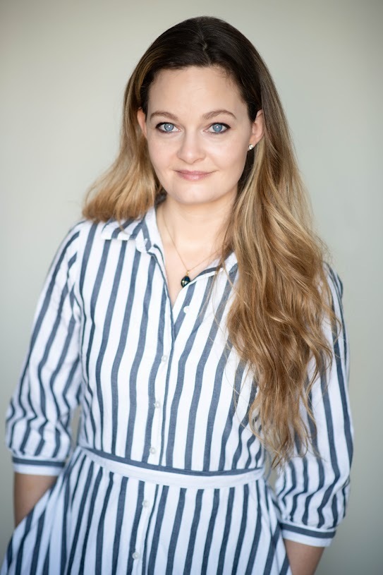 Portrait of a woman in a striped shirt dress.