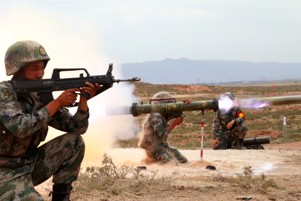 Chinese soldiers firing anti-tank rockets during a military exercise.