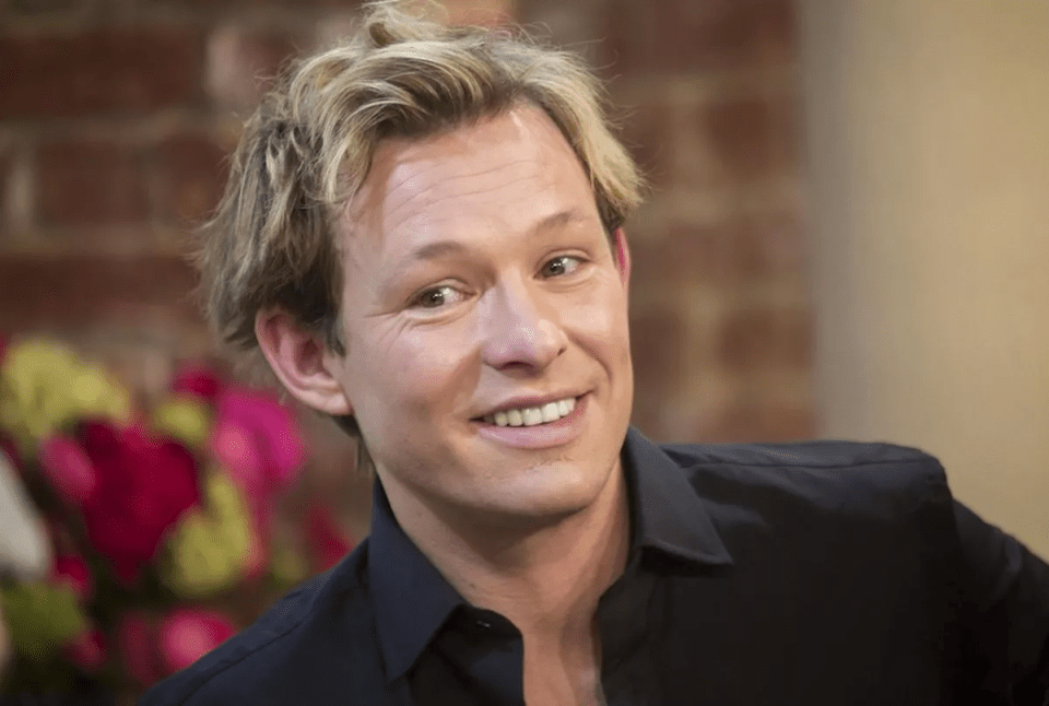 Headshot of a man smiling.