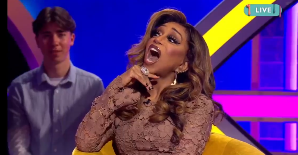 Woman reacting on a live TV show.