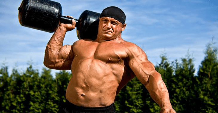 Muscular man lifting a heavy weight.