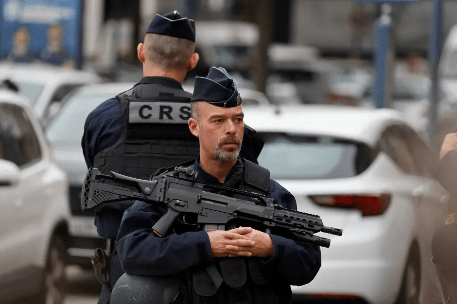 Police officer with rifle.