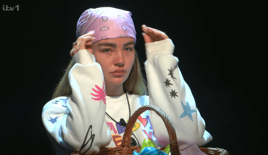 Woman adjusting a headscarf.
