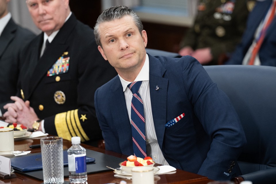Man in suit at a meeting.