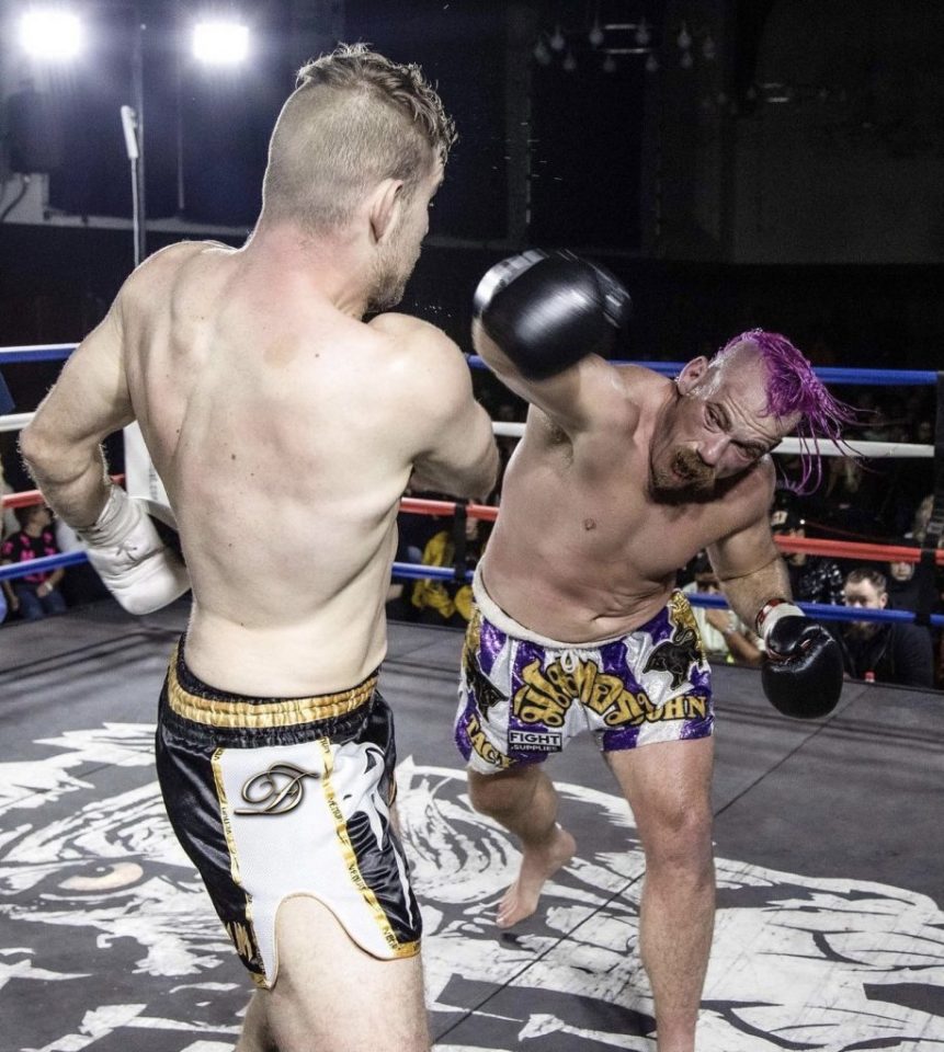 Two Muay Thai fighters in a boxing ring exchanging blows.